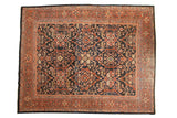 Rectangular vintage Mahal carpet with a black field featuring intricate floral and geometric patterns in rust, cream, and blue, surrounded by multiple patterned red and beige borders.