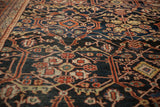Detailed vintage Mahal carpet with intricate geometric and floral patterns in muted reds, blues, and beige tones, showing fine craftsmanship and traditional design.