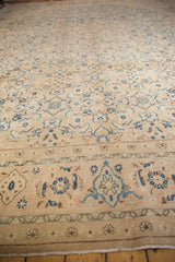 Vintage Mahal carpet with faded beige background and intricate blue and brown floral and geometric patterns, bordered by a cream band with small floral motifs.