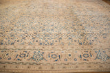 Vintage Mahal carpet with a soft beige background and intricate blue floral and geometric motifs evenly distributed across its surface and bordered edges.