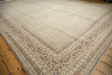 Large 11x15 vintage distressed Sivas carpet with faded beige and brown geometric patterns and floral border, laid on a wooden floor.