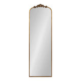 Tall rectangular mirror with a rounded top and an ornate carved floral accent in a warm wood frame, shown on a white background.