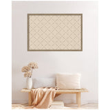 Framed beige print with thin dark green crisscross lattice pattern hanging above a wooden bench with neutral cushions and a textured vase holding dried flowers.