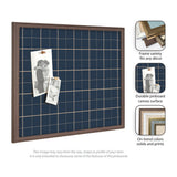 Square pinboard with navy blue plaid fabric featuring thin tan grid lines and a dark wood frame, displaying two black-and-white photos clipped on the surface.