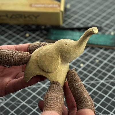 Elephant Carving Kit with hand-forged knife, wood blocks, sandpaper, sharpening board, pencil, and elephant drawing