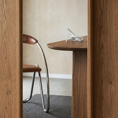 Oval solid wood dining table with chestnut wood finish and custom solid wood legs