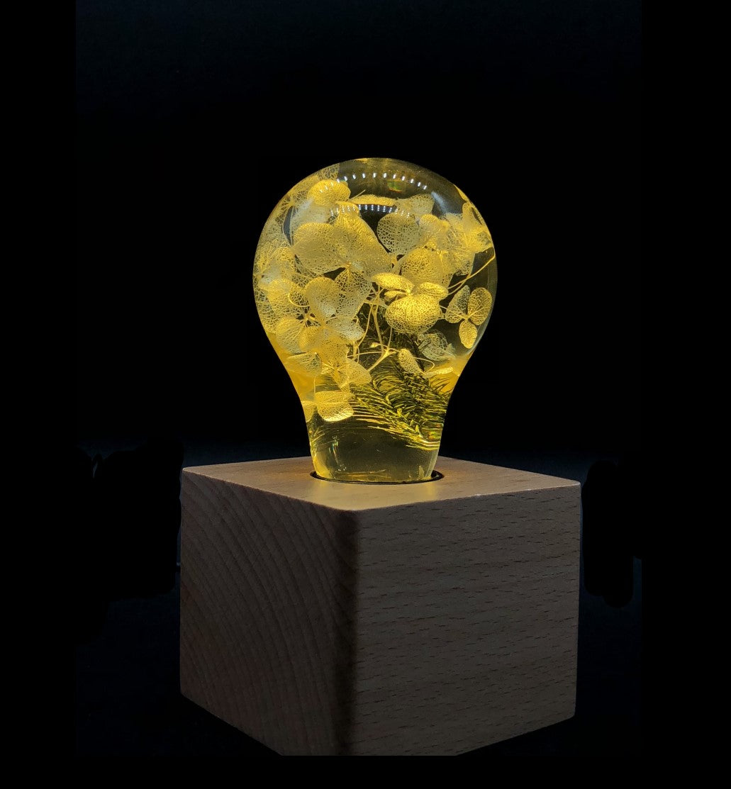 Three handcrafted flower-shaped resin LED bulbs in a 3-pack