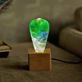 EP Light Spring Resin LED Bulb with green resin design on wooden base