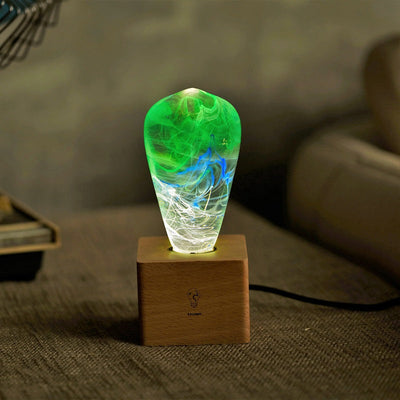 EP Light Spring Resin LED Bulb with green resin design on wooden base