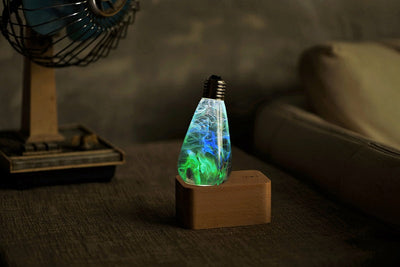 EP Light Spring Resin LED Bulb with green resin design on wooden base