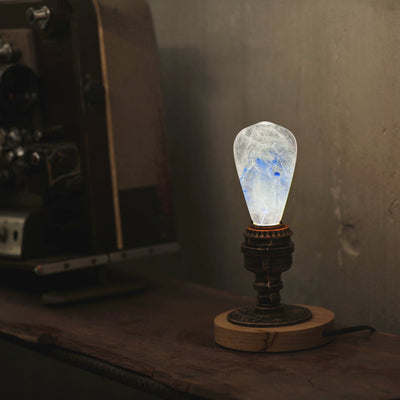 EP Light Blue-Drop Resin LED Bulb handcrafted with eco-friendly resin, shown with wooden base options