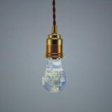 Three handcrafted flower-shaped resin LED bulbs in a 3-pack