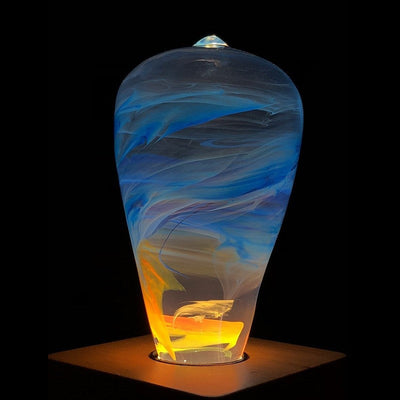 EP Light Fire Decorative Resin LED Bulb with glowing fire effect inside, shown with wooden base options