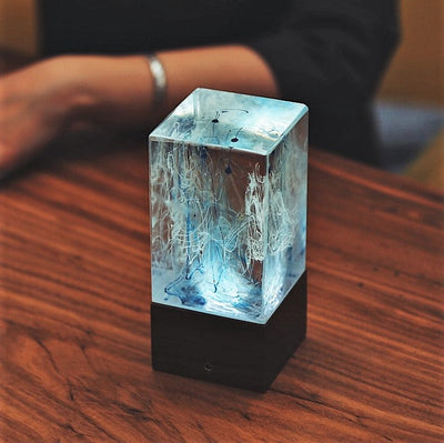 Handcrafted resin table lamp with ocean-inspired colors and warm white LED light