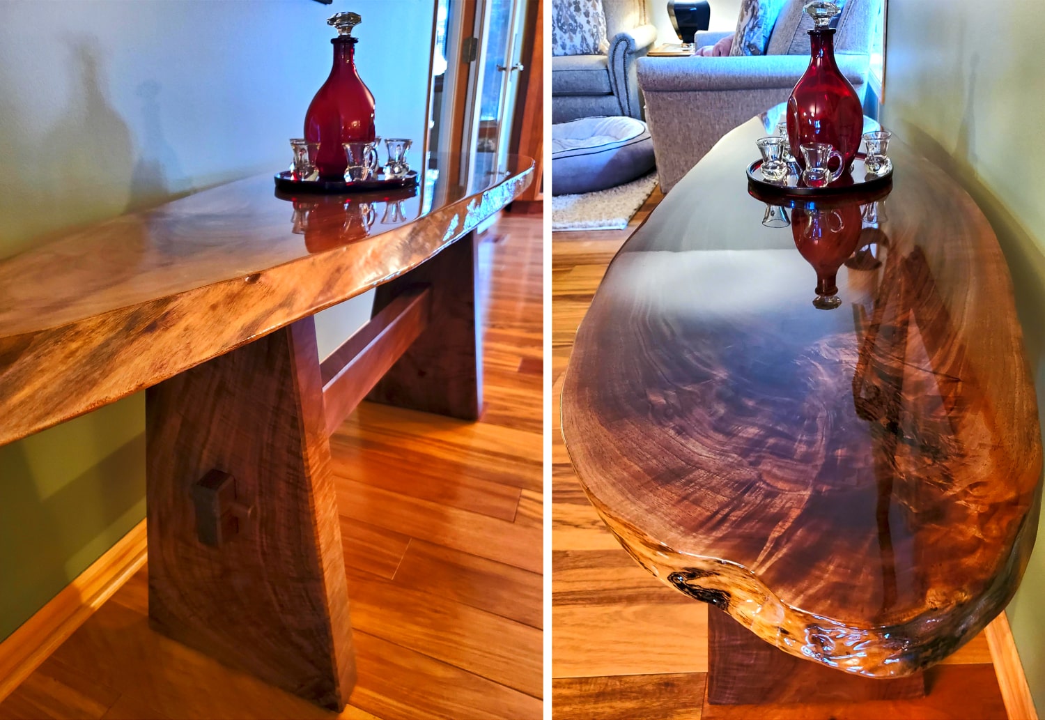 Wooden console table with a red vase and small glasses on top, set against a neutral wall.