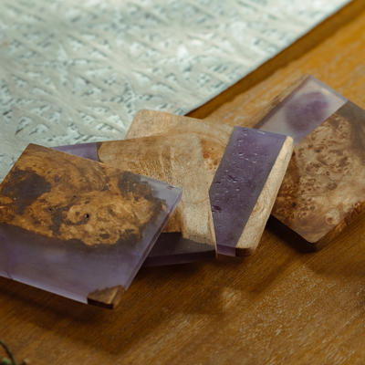 Colorful epoxy handcrafted coasters stacked with visible smooth surfaces and varied artistic patterns.