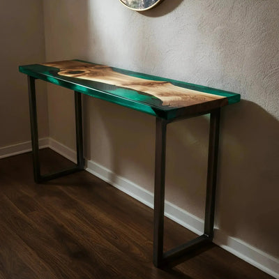 Sunlit Forest Console Table with walnut wood and green epoxy resin, handmade in the USA, shown in modern entryway setting.