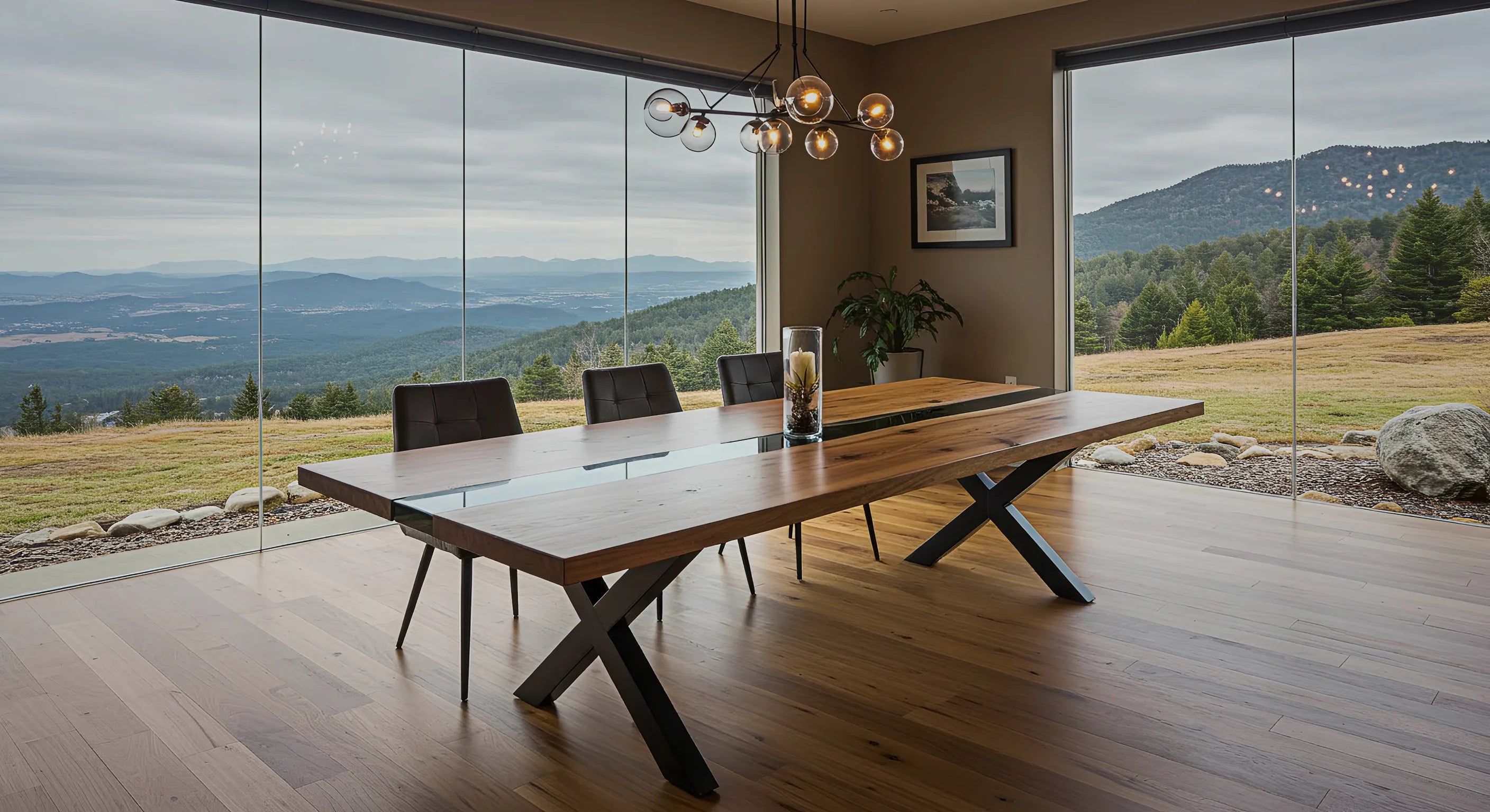 Epoxy Dining Table with black epoxy river, walnut wood, and metal x shaped legs in a luxury dining room with a scenic view from the top of a mountain overlooking the forest