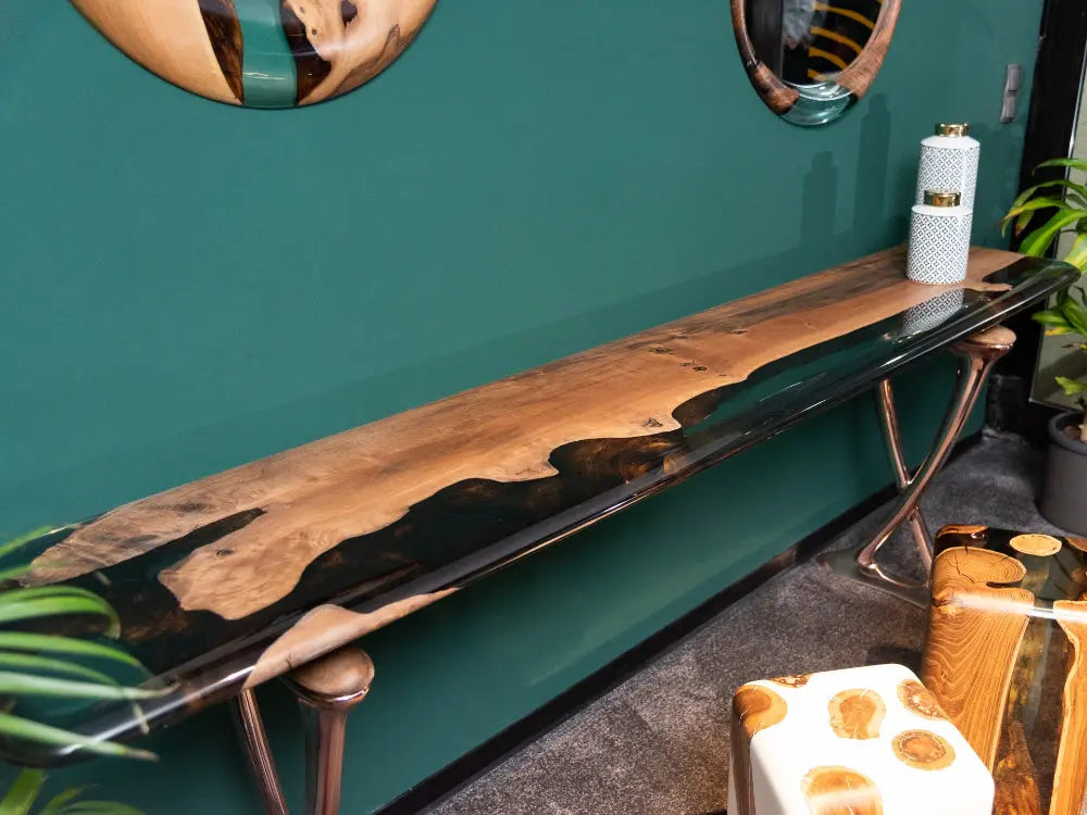 Handcrafted resin console table with walnut wood and epoxy resin top, featuring rose gold aluminum legs from Osso Collection