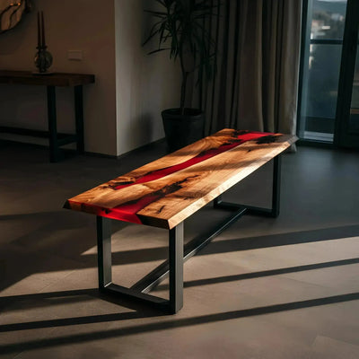 Custom epoxy bench featuring walnut wood and red resin with black metal legs. Handmade in the USA, ideal for dining or kitchen seating.