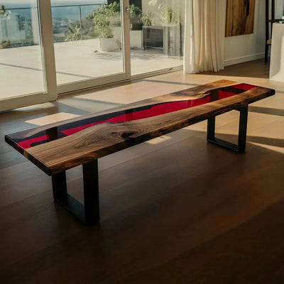 Custom epoxy bench featuring walnut wood and red resin with black metal legs. Handmade in the USA, ideal for dining or kitchen seating.