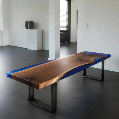 Walnut and blue resin epoxy bench in a minimalist dining space. Custom handmade USA furniture supporting marine conservation.