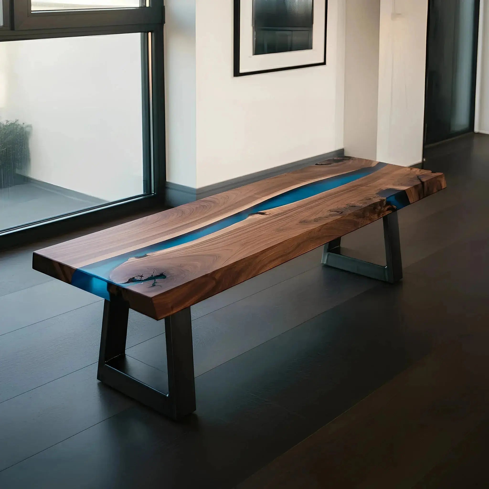 Custom handmade epoxy bench featuring live edge walnut and blue resin. Stylish dining bench with industrial metal legs.