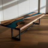 Custom epoxy bench with walnut wood and vibrant blue resin, handmade in the USA. Modern dining bench with sleek black metal legs.
