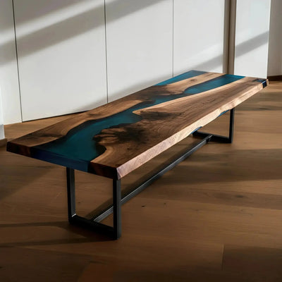 Custom epoxy bench with walnut wood and vibrant blue resin, handmade in the USA. Modern dining bench with sleek black metal legs.