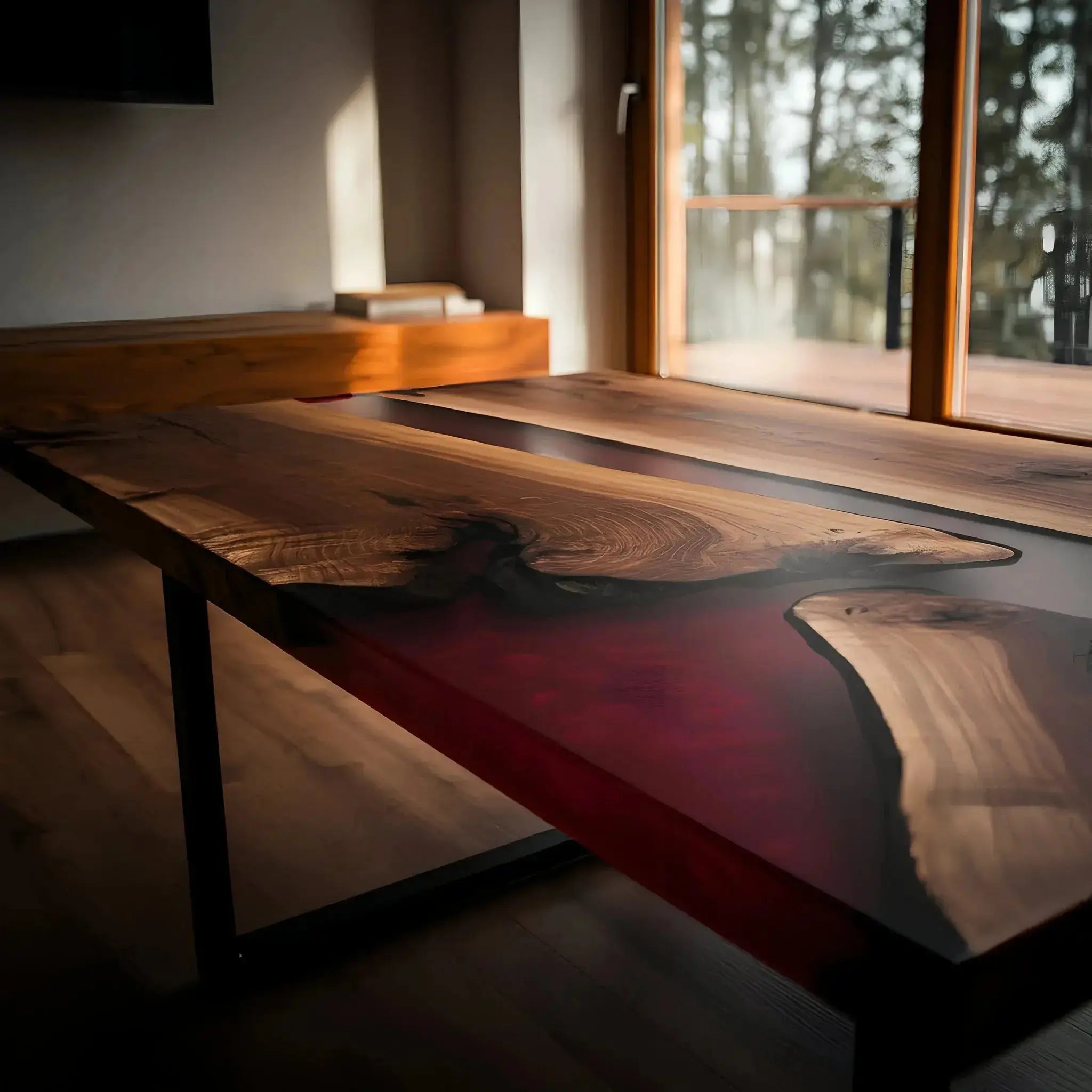 Close-up of custom epoxy coffee table with deep red resin and live edge walnut wood. Elegant handmade furniture piece for contemporary interiors.