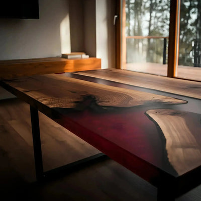 Handmade walnut and red epoxy resin coffee table with black metal legs, shown in a modern living room setting.
