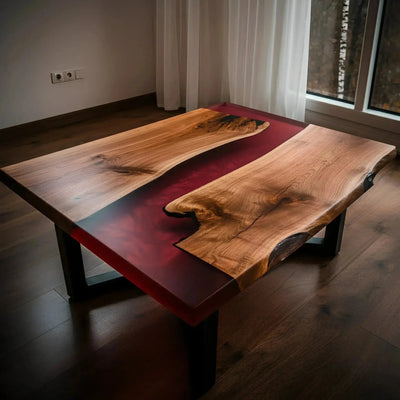 Handmade walnut and red epoxy resin coffee table with black metal legs, shown in a modern living room setting.