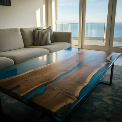 Custom epoxy coffee table with live edge walnut and deep blue resin river design, handmade in the USA. Modern hairpin legs add industrial flair.