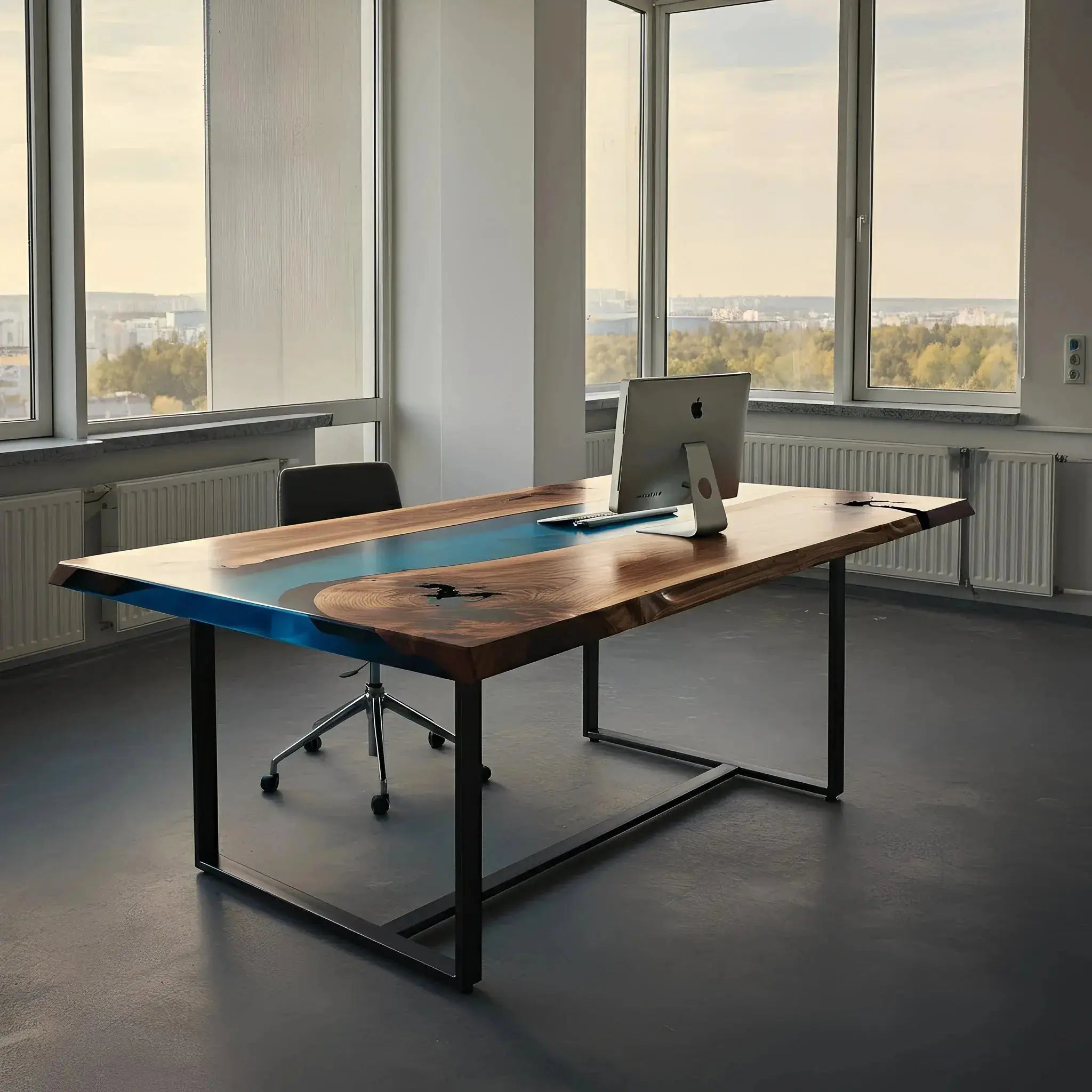Epoxy river office desk with blue resin and walnut wood top in a bright corner office. Custom crafted in the USA with modern industrial design.