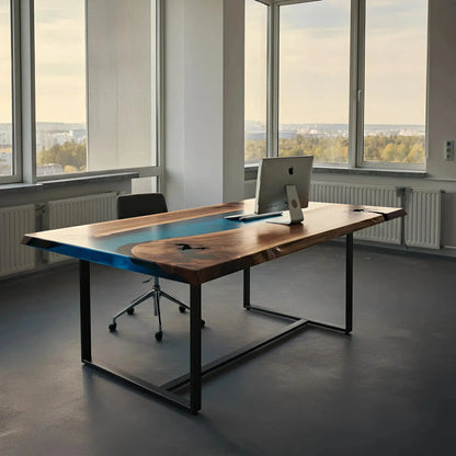 Epoxy river office desk with blue resin and walnut wood top in a bright corner office. Custom crafted in the USA with modern industrial design.