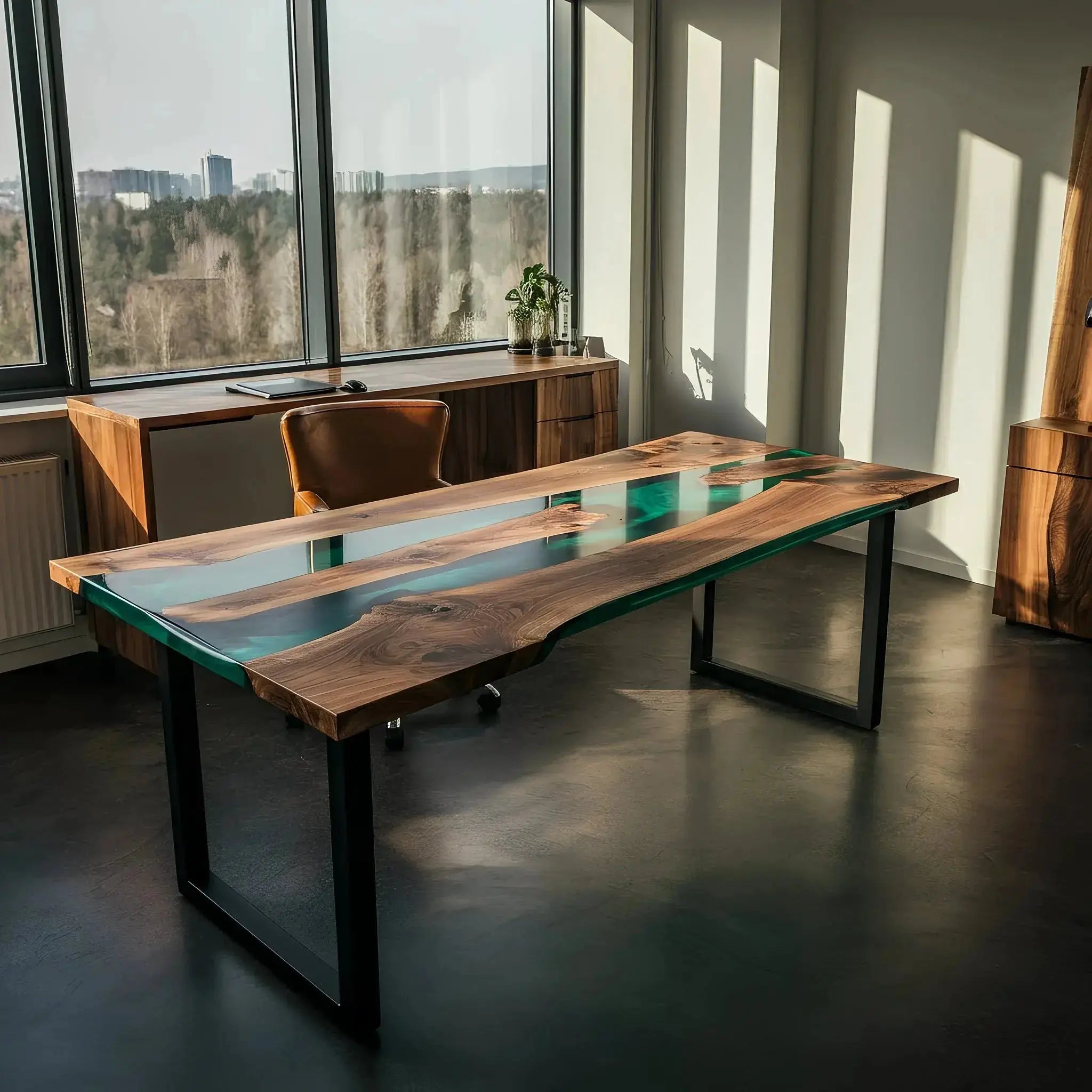 Sunlit epoxy river office desk crafted from walnut and green resin. Custom USA-made desk with sleek black legs and panoramic window view.