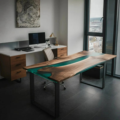 Handcrafted walnut wood office desk with green epoxy resin accents and black metal legs, modern design in a bright workspace.