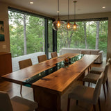 Custom epoxy black dining table with walnut wood and black resin center, handmade in the USA. Modern rectangular design with metal legs.