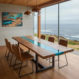 Custom epoxy ocean dining table with walnut wood and blue resin river, handmade in the USA with modern metal X-leg base