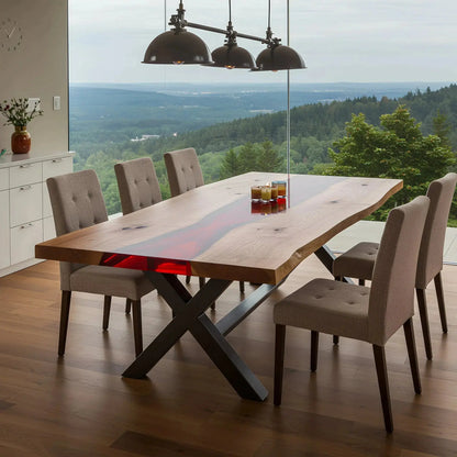 Custom walnut and red resin epoxy river dining table with X-frame legs, styled in a scenic dining room. Handmade USA furniture supporting conservation.