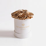 Essence Beige Suede Box with seven gold roses arranged inside