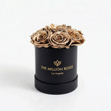 Black box containing seven gold roses from The Million Roses Essence Black Box collection