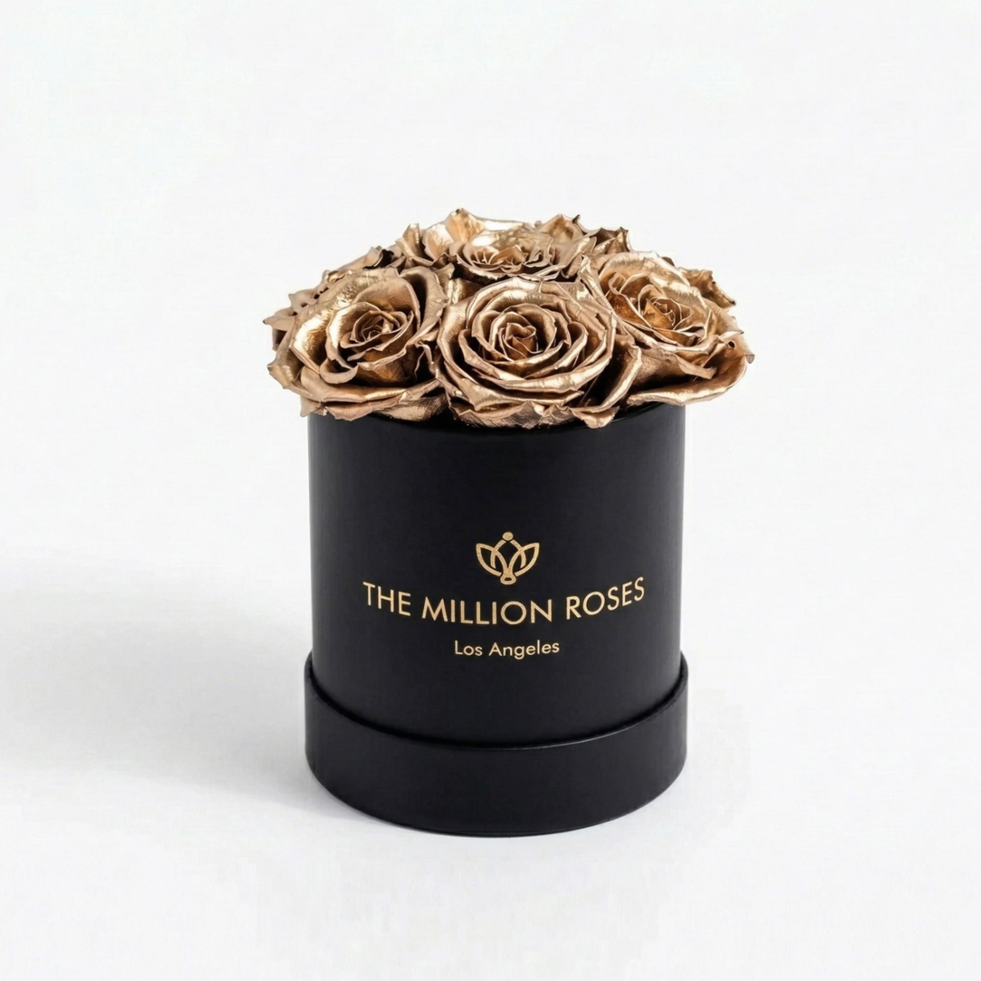 Black box containing seven gold roses from The Million Roses Essence Black Box collection