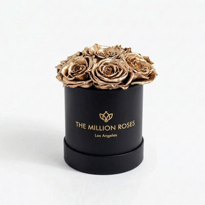Black box containing seven gold roses from The Million Roses Essence Black Box collection