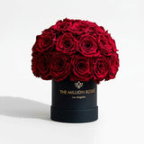 Black Superdome box filled with 38-40 vivid red roses arranged in a rounded crown