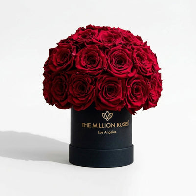 Black Superdome box filled with 38-40 vivid red roses arranged in a rounded crown