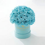 Essence Mint Green Suede Superdome Box holding a rounded crown of turquoise roses