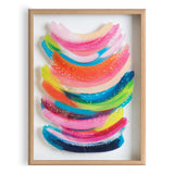 Abstract framed print featuring layered curved brushstrokes in pink, orange, blue, green, and yellow, accented with small white dots on a white background.