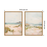 Two framed canvas paintings depicting soft, sandy dunes and gentle ocean waves under pale blue skies, each measuring 38 by 24 inches outer size.