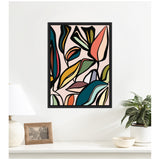 Abstract wall art print with bold outlined leaves in teal, mustard, coral, and black on a pale pink background, framed and hung above a white shelf with decor.